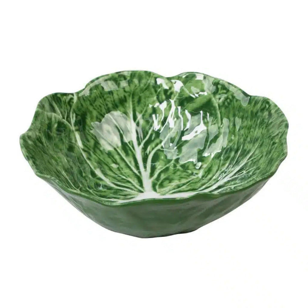 Green ceramic bowl shaped like a cabbage leaf on a white background