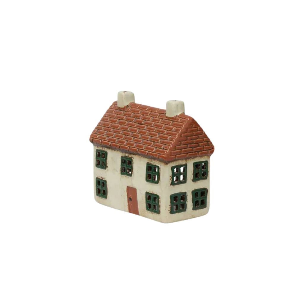 Small model of a house with a red roof on a white background