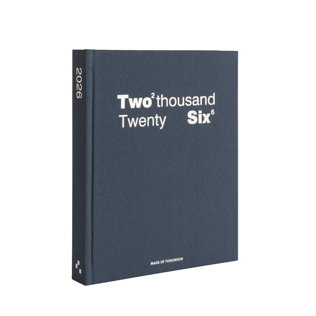 Blue notebook with 'Two thousand Twenty Six' text on a white background