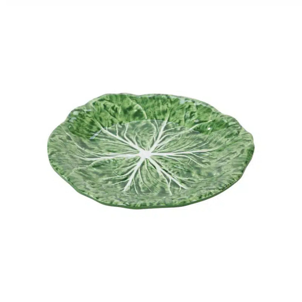 Green leaf-shaped plate on a white background