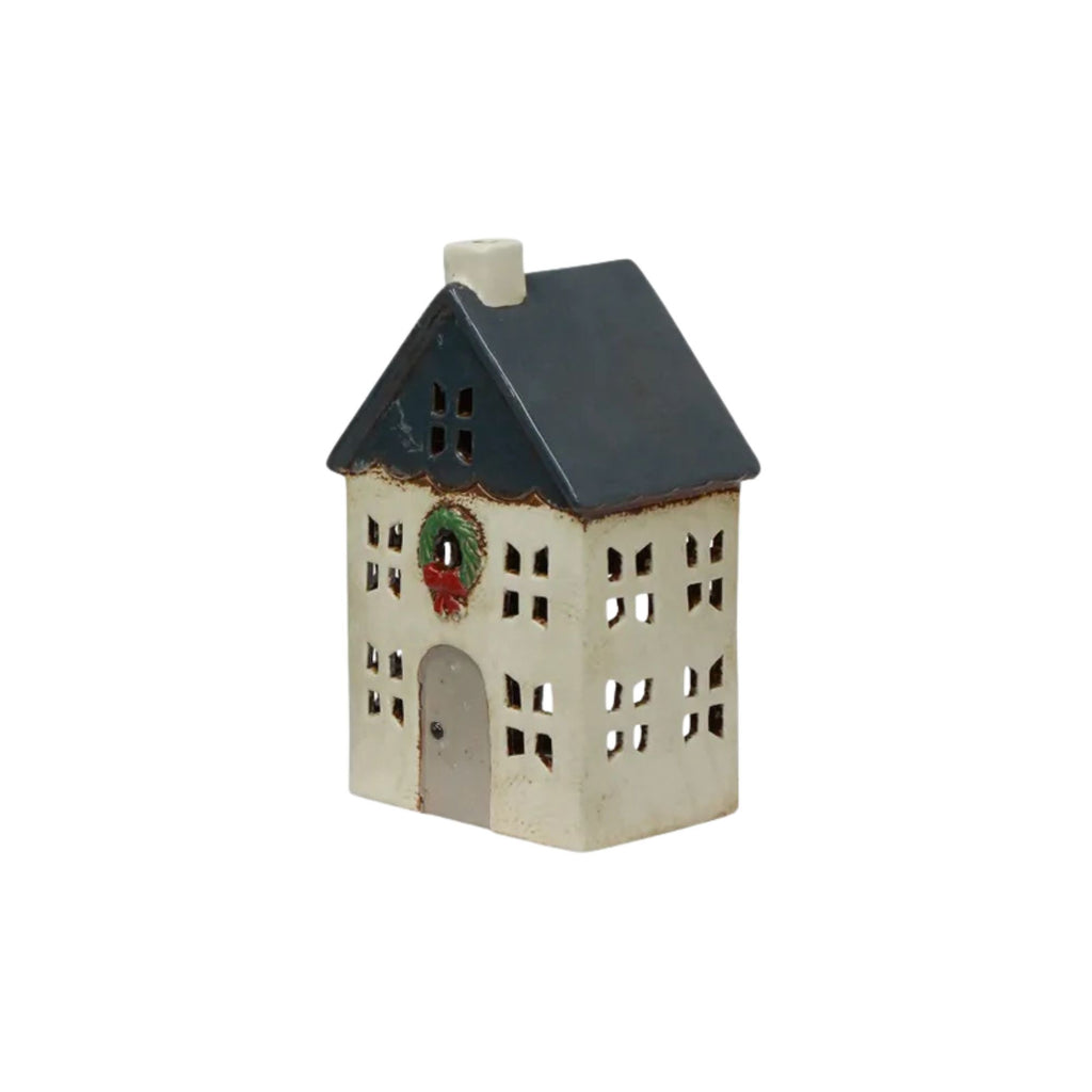 Decorative house-shaped lantern with a wreath on a white background