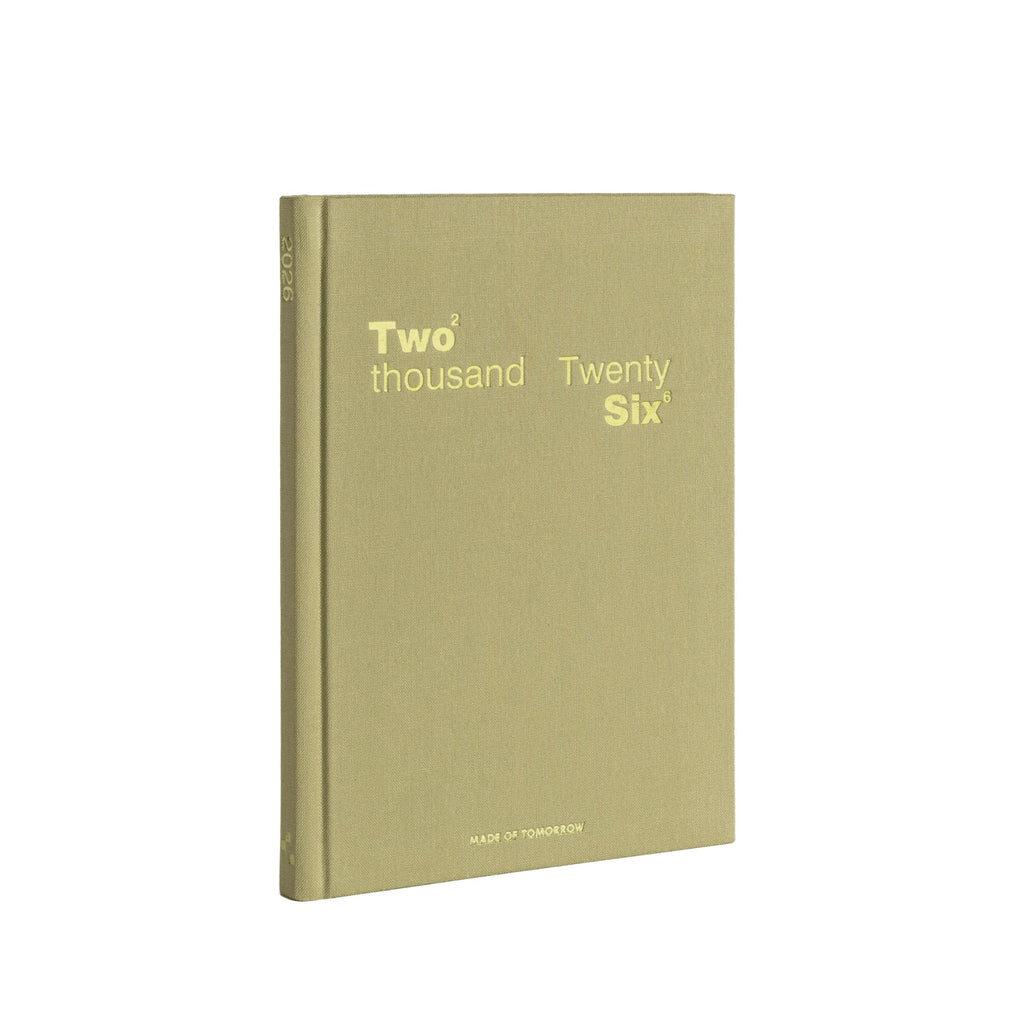 Green notebook with 'Two thousand Twenty Six' text on a white background