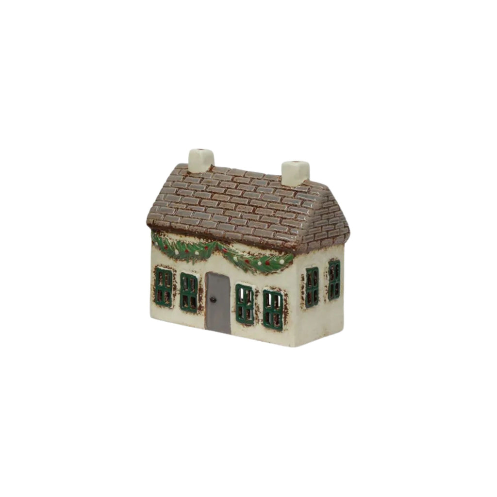 Small model of a house with a brown roof and white walls on a white background