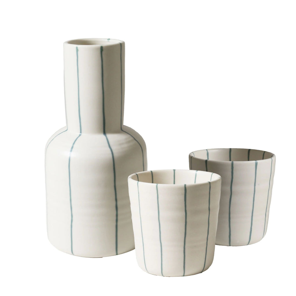 Set of three ceramic vases with blue stripes on a white background