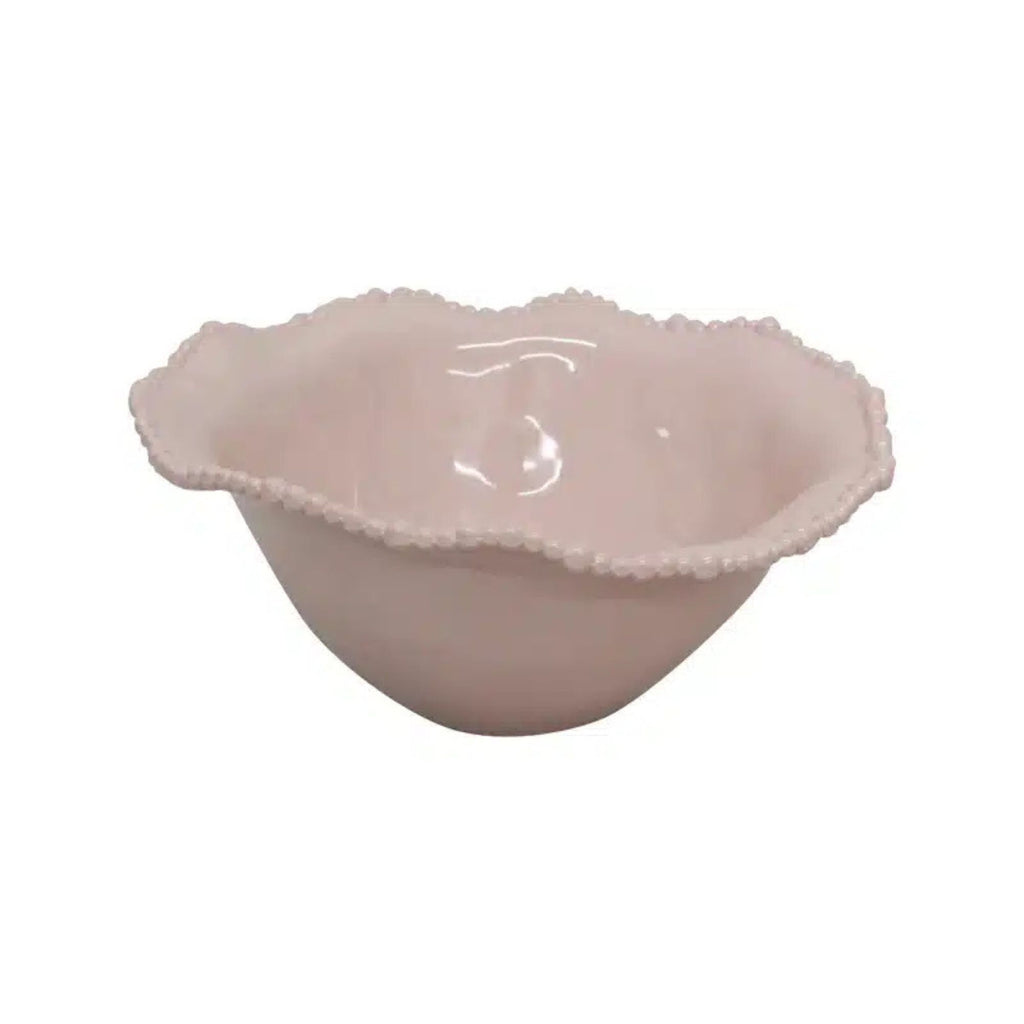 Pink ceramic bowl with scalloped edge on a white background