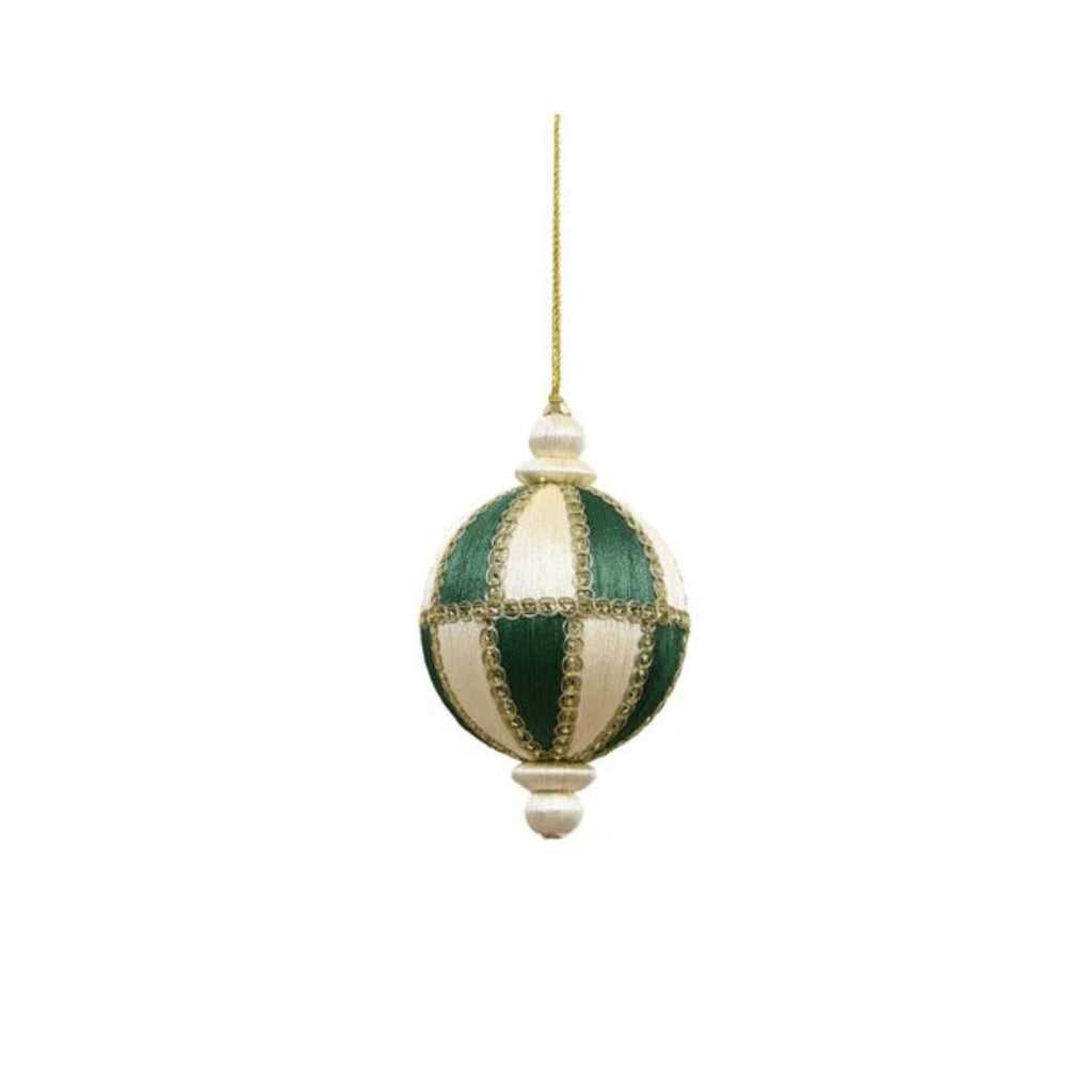 Decorative green and white striped ornament with gold accents on a white background