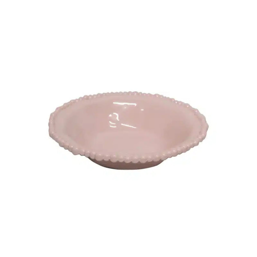 Pink ceramic bowl with textured rim on a white background