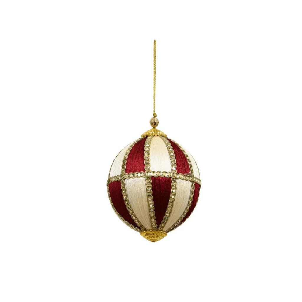 Decorative Christmas ball ornament with red and gold pattern on a white background