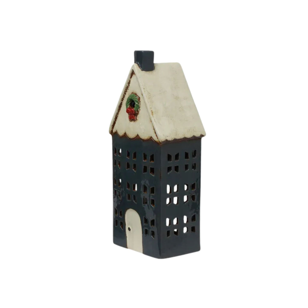 Decorative house-shaped lantern with a white roof and black body on a white background