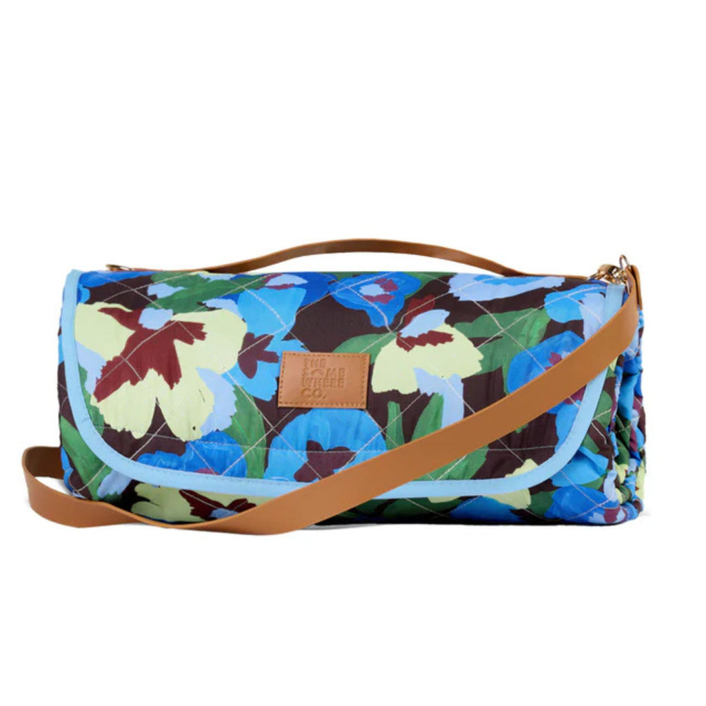 Floral-patterned bag with a brown strap on a white background