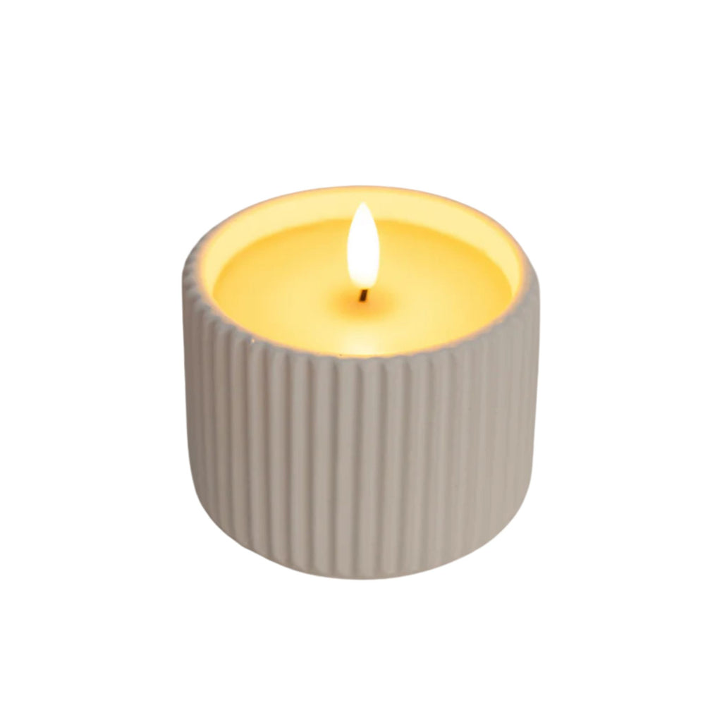 Candle with a ribbed gray container on a white background