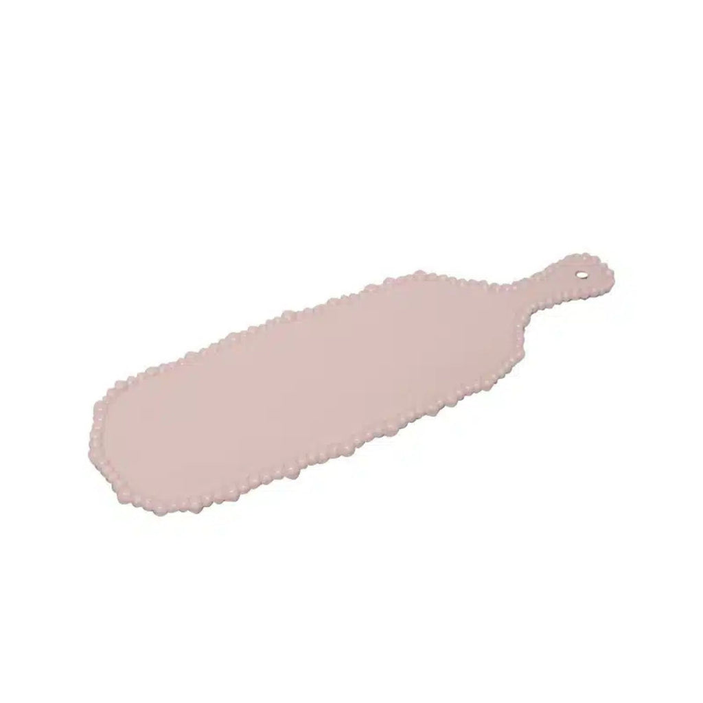 Pink cutting board with decorative edge on a white background