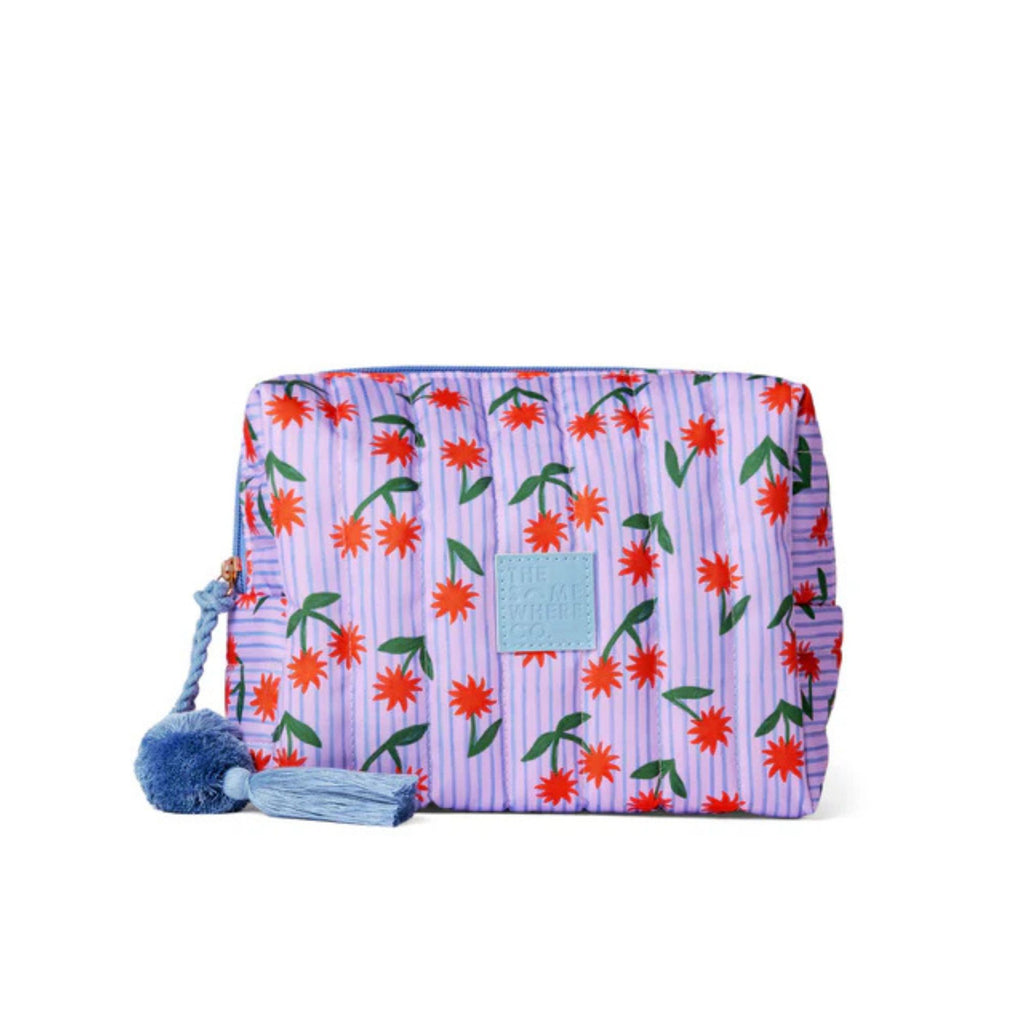 Floral patterned pouch with a blue tassel on a white background