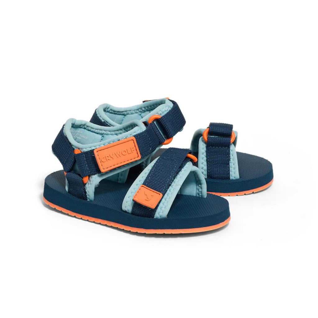 Pair of blue and orange sandals on a white background