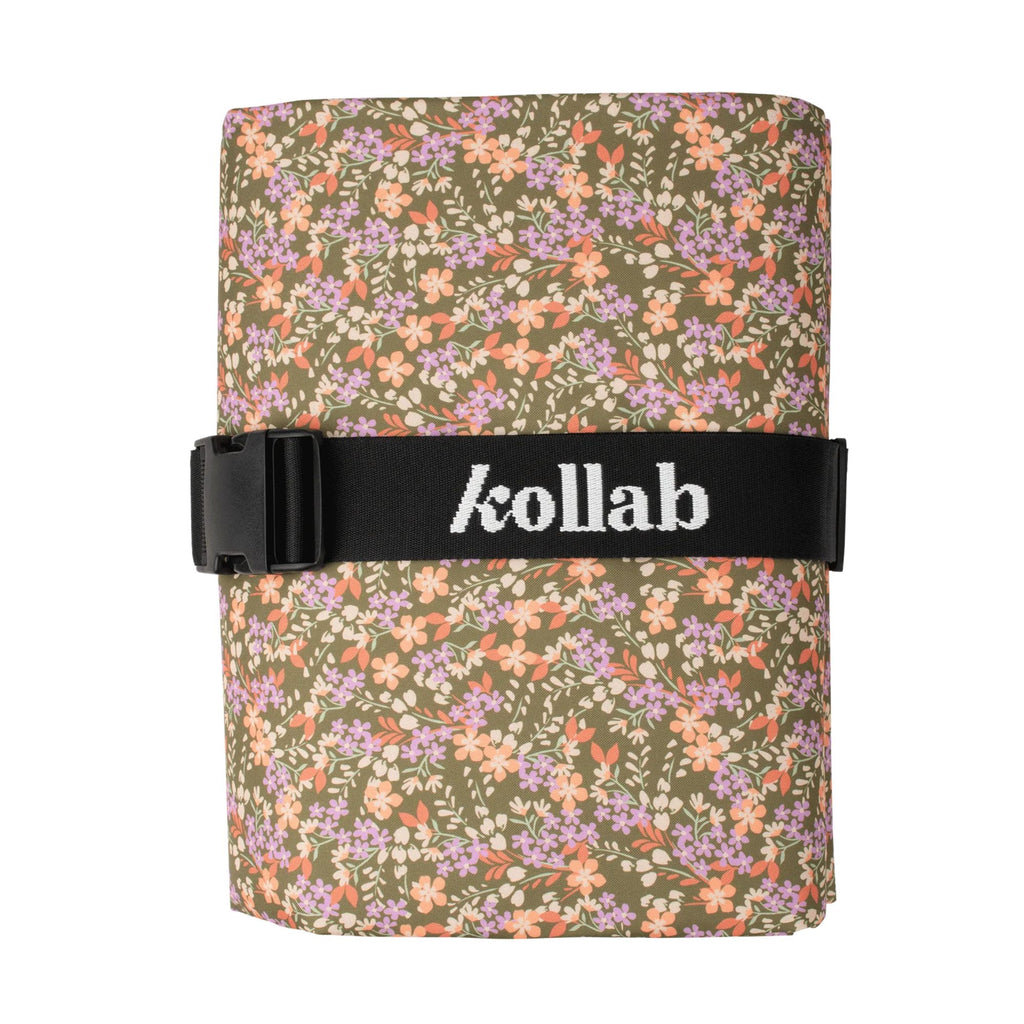 Floral-patterned mat with a black strap displaying 'kollab' on a white background