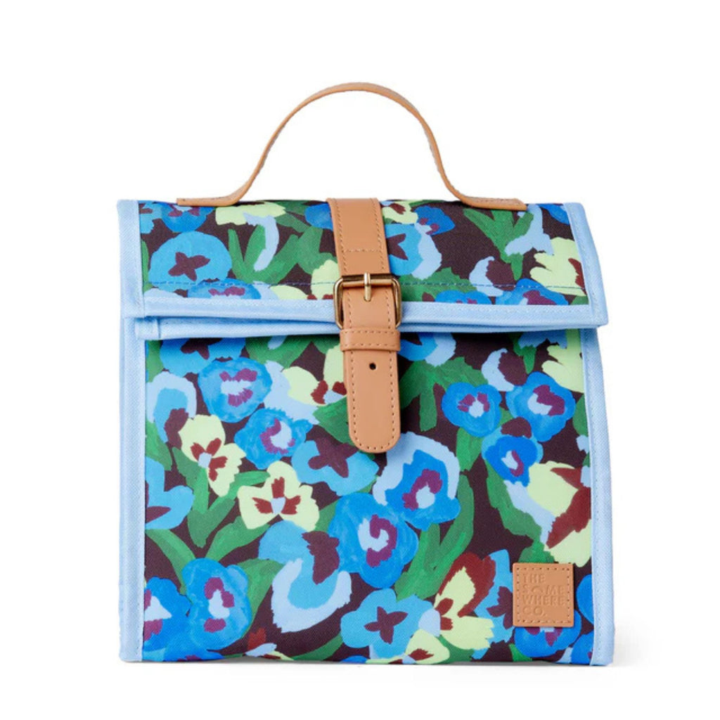 Floral patterned bag with brown strap and buckle on a white background