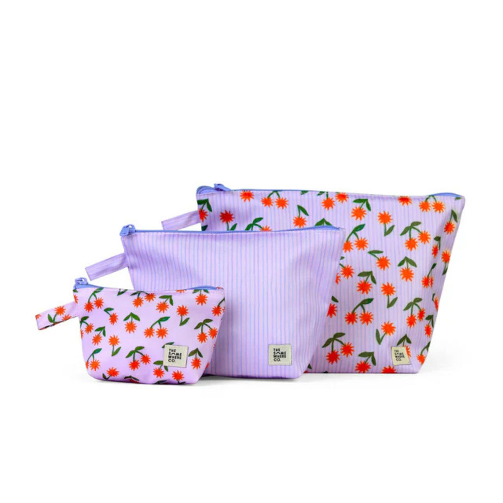 Set of three floral-patterned pouches on a white background
