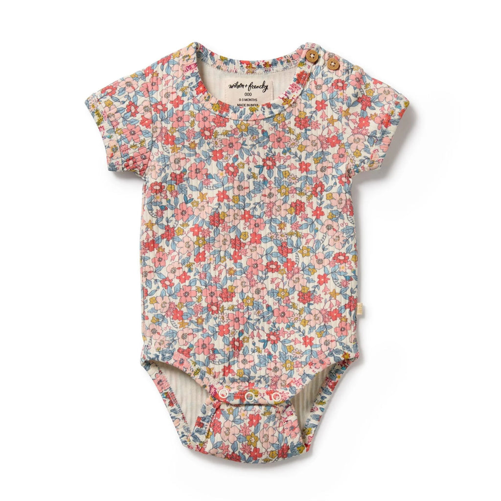 Floral-patterned baby bodysuit on a white background