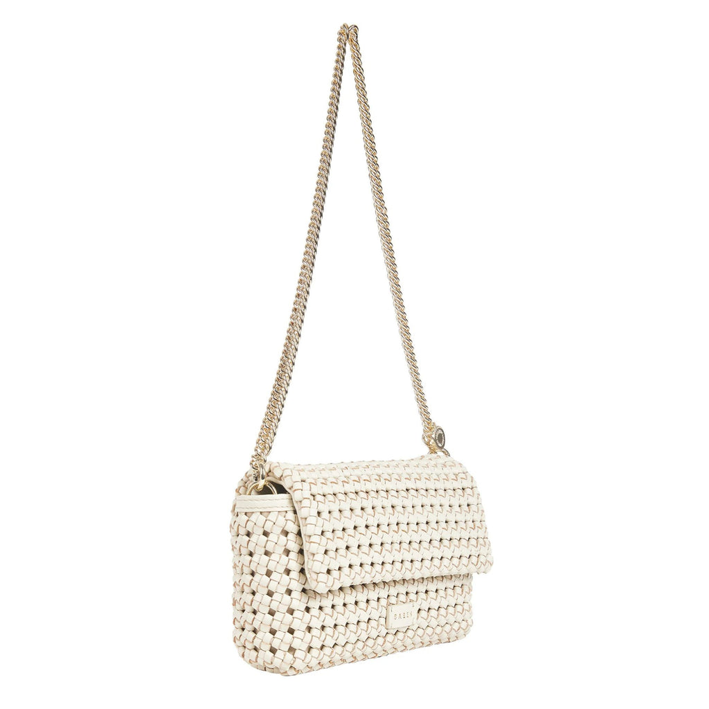 A cream Saben brand baguette shaped purse composed of braided cream leather with a gold chain