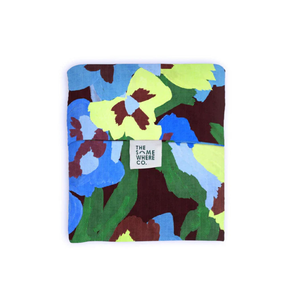 Colorful floral-patterned pouch with 'The Somewhere Co.' label on a white background