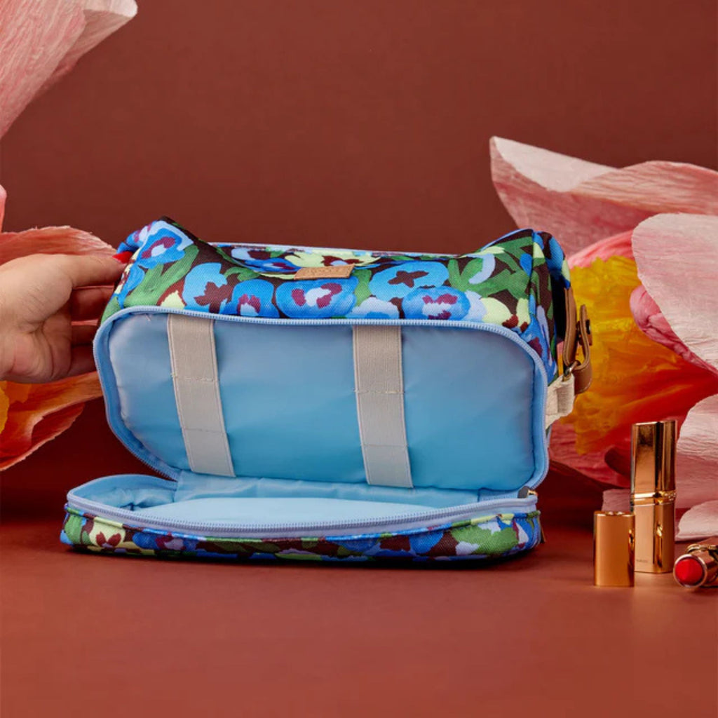 Colorful makeup bag with floral pattern on a red background
