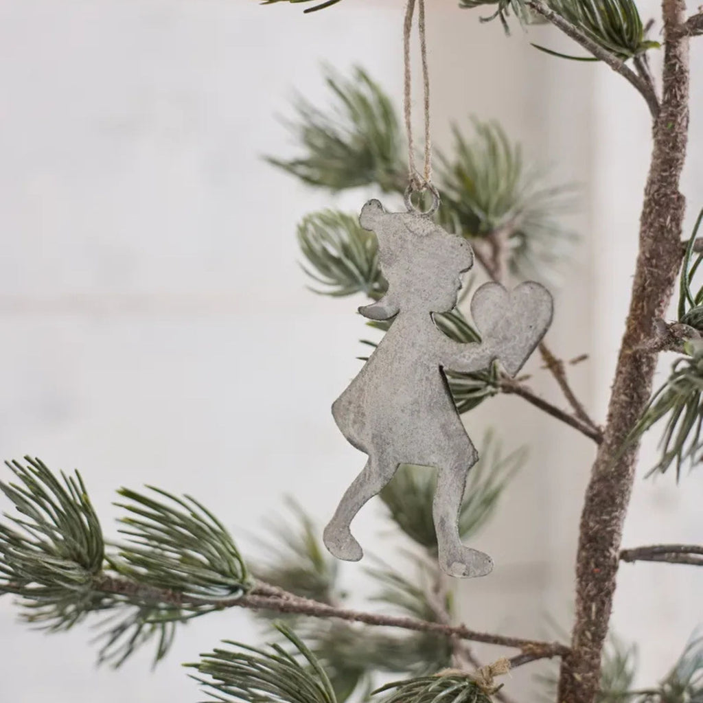 Decorative ornament hanging on a tree branch with a blurred background