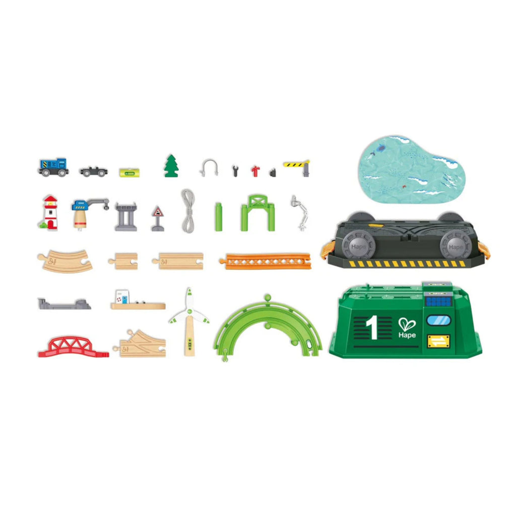 Collection of toy train track pieces and accessories on a white background