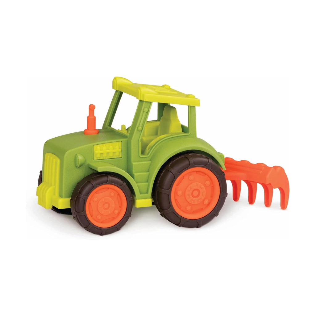 Toy tractor with green body, orange wheels, and red implement on a white background