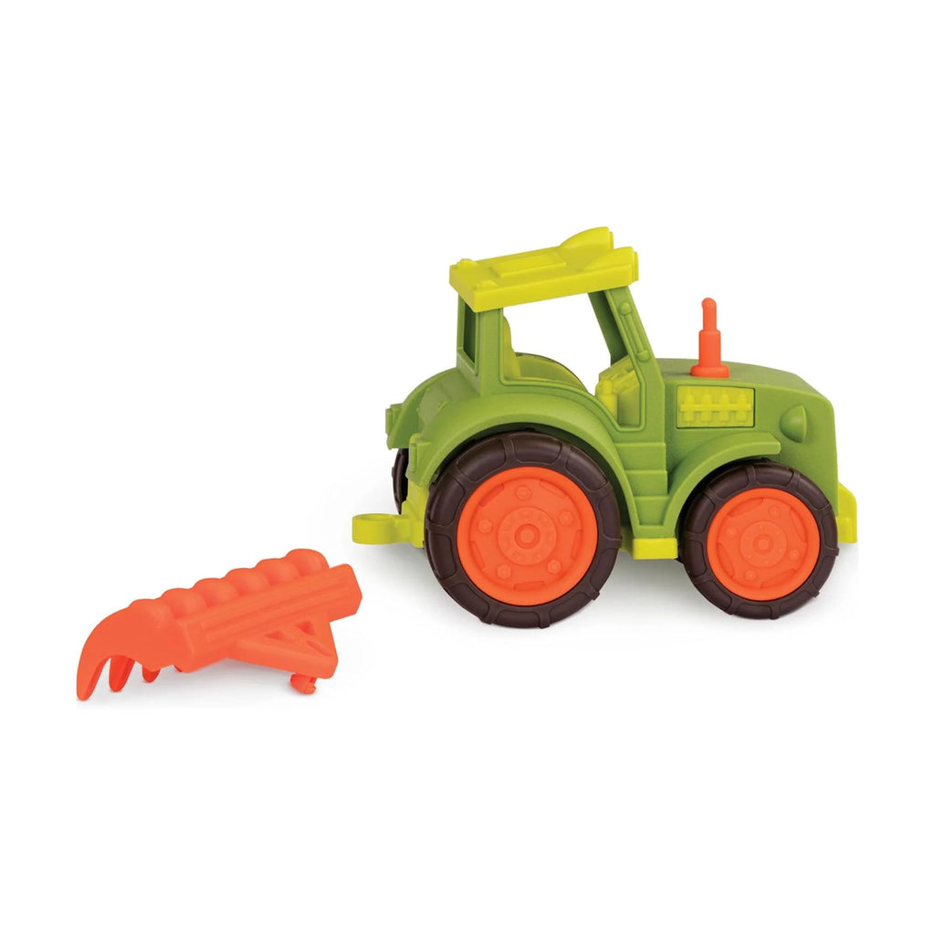 Toy tractor with orange wheels and a red tool on a white background
