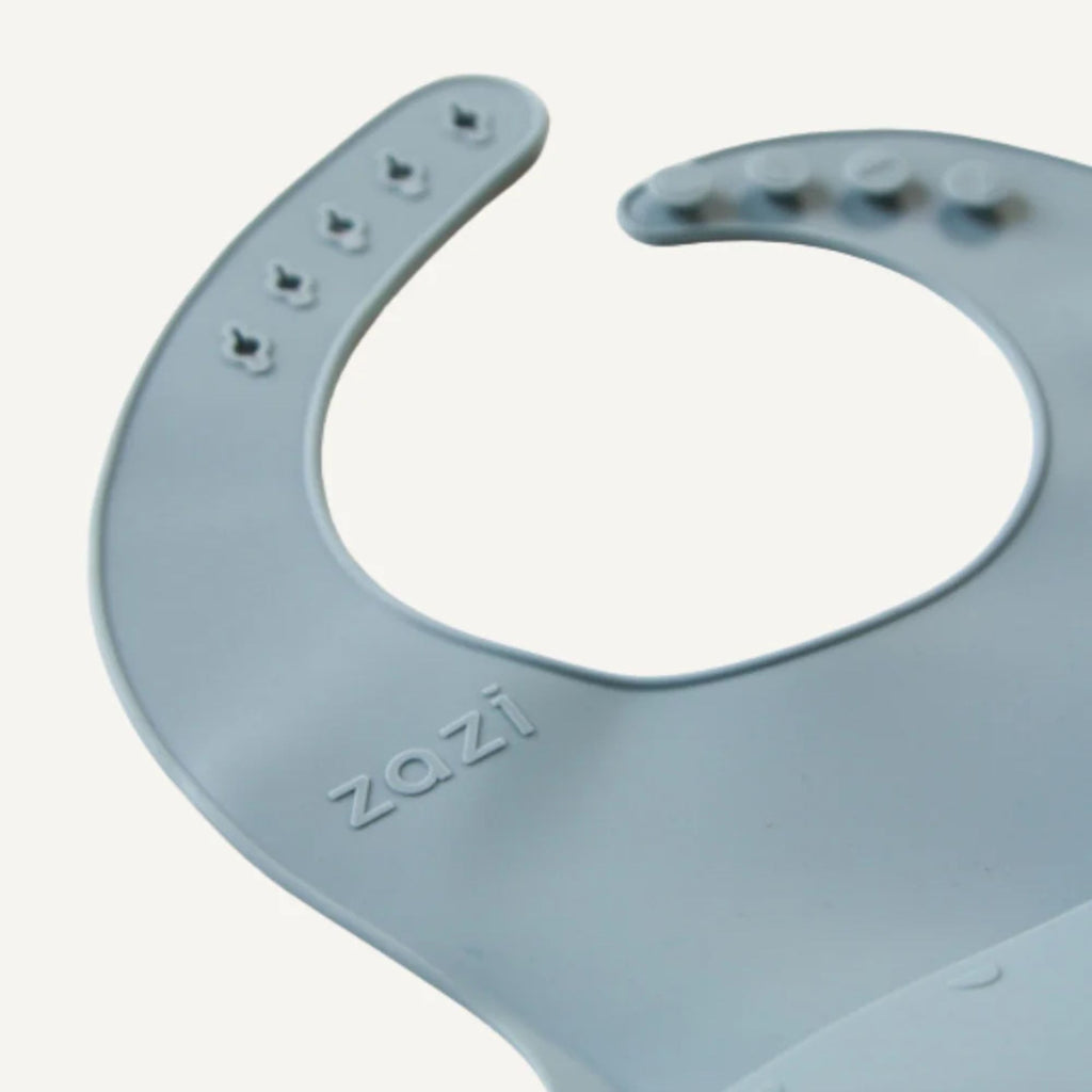 Gray silicone bib with 'ZAZI' branding on a white background