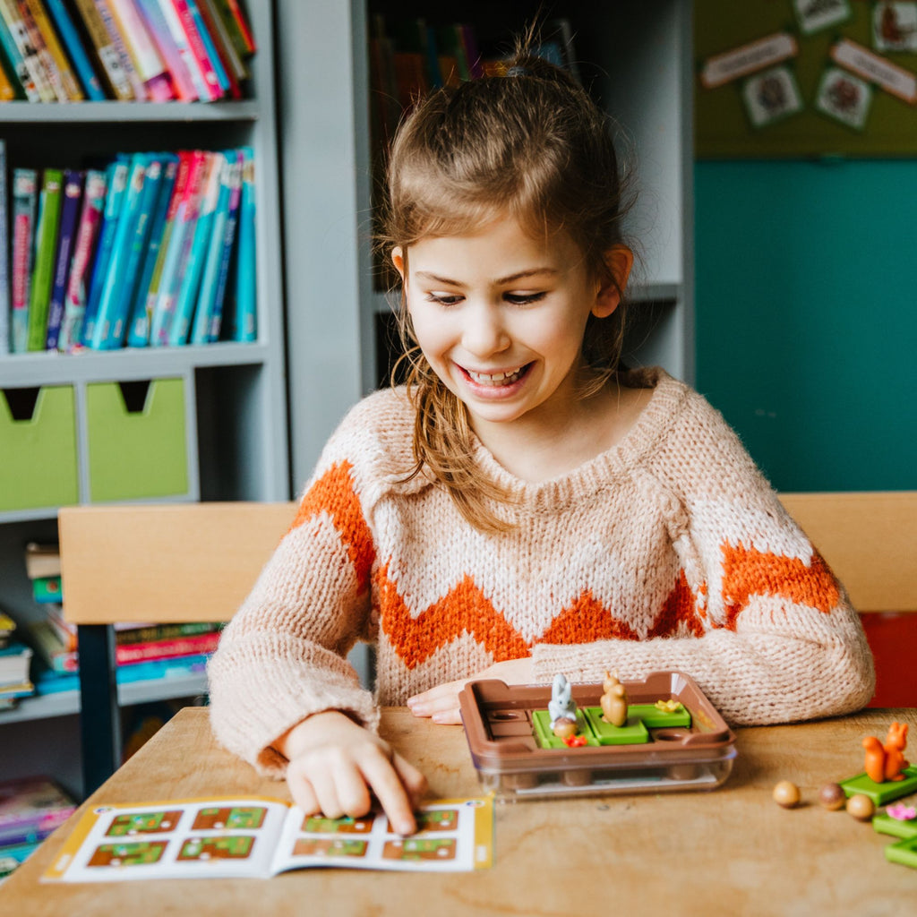 Young girl playing with a toy in a classroom setting