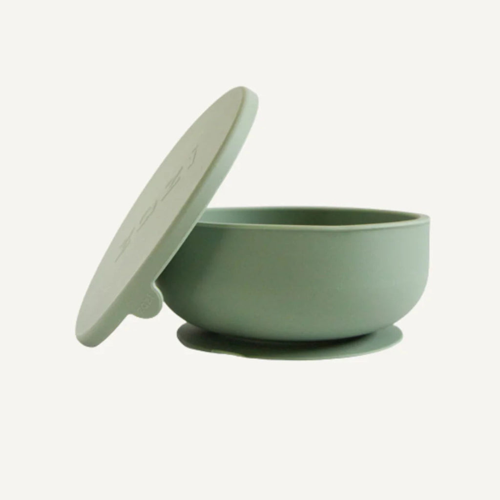 Green bowl with lid on a white background