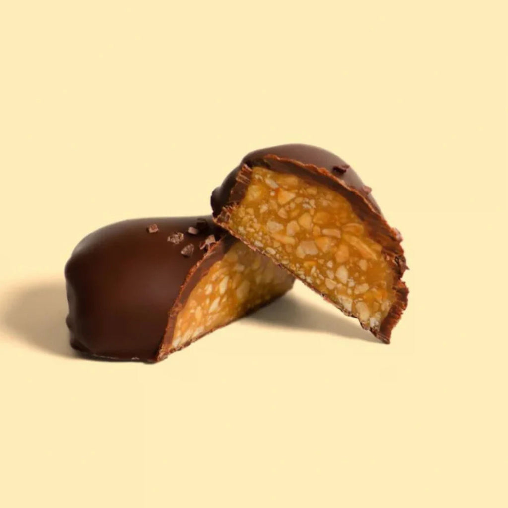 Chocolate-covered caramel treat on a beige background