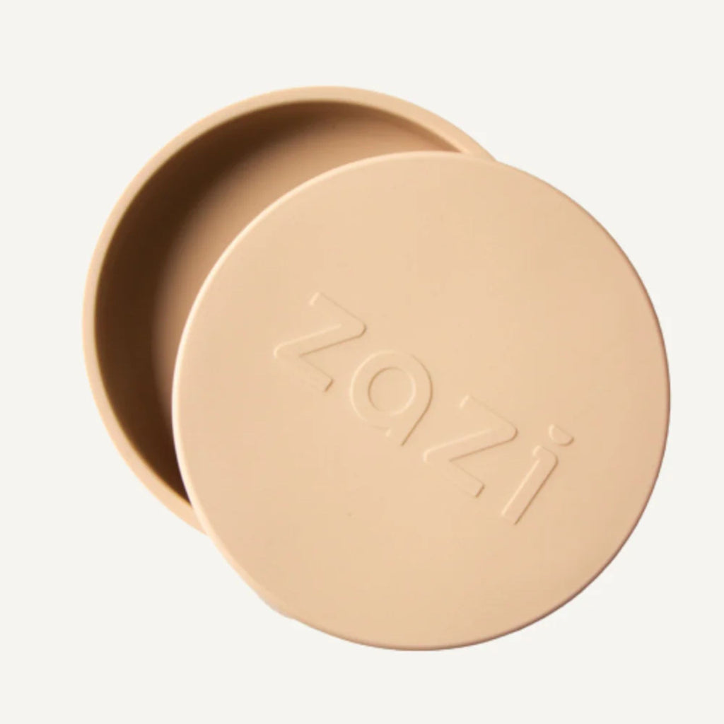 Beige silicone dish with lid on a light gray background