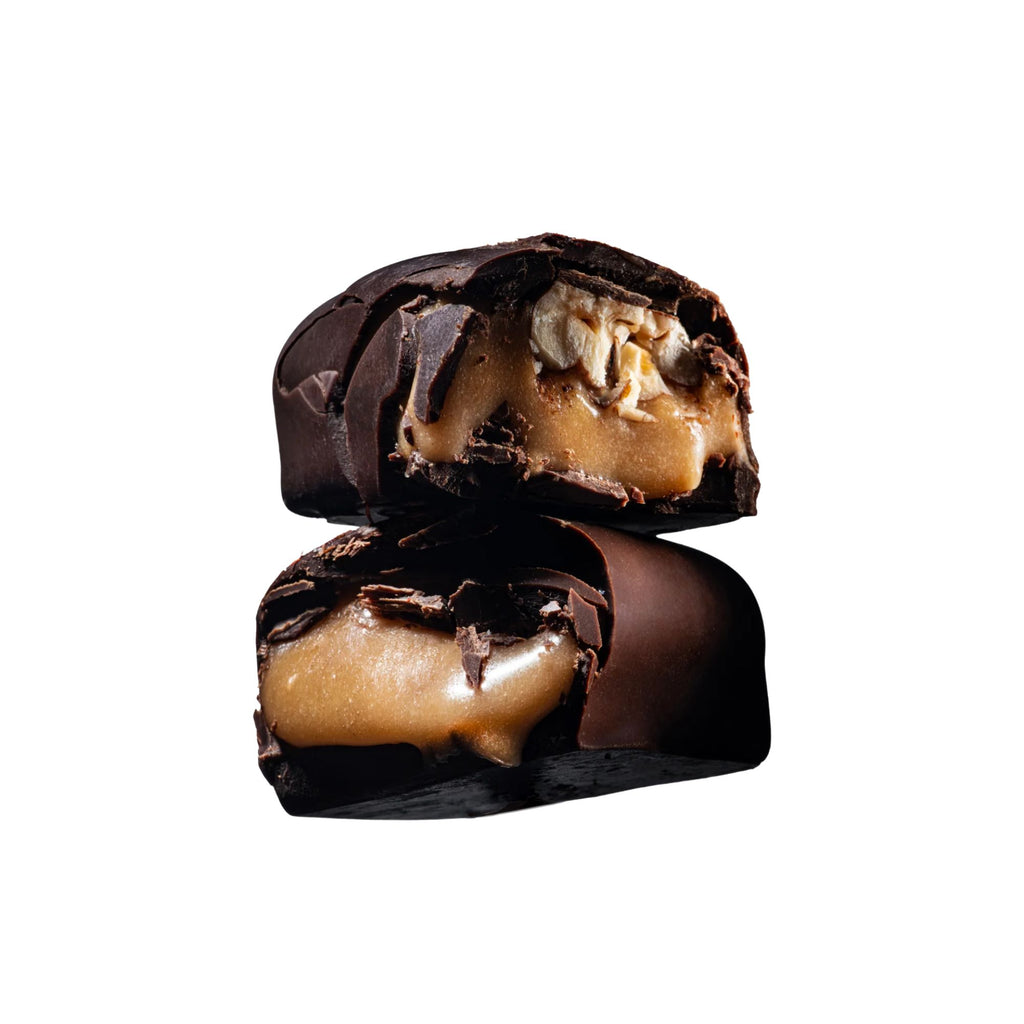 Two chocolate-covered treats with a creamy center on a white background