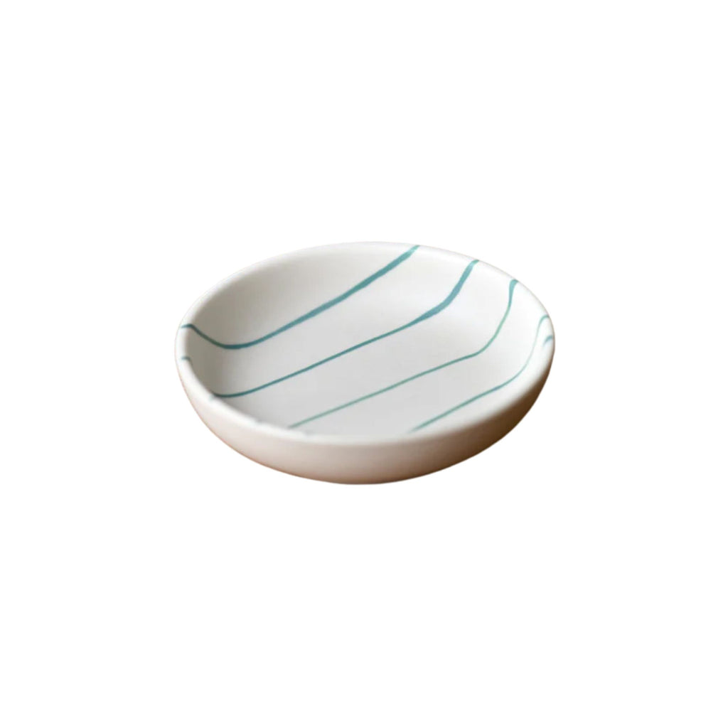 Small ceramic dish with blue stripes on a white background