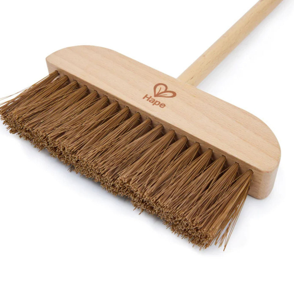 Wooden broom with brown bristles on a white background, featuring the Hape logo.