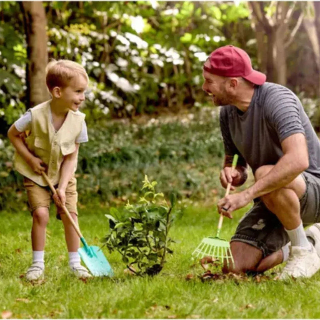 Man and child gardening together in a lush green garden