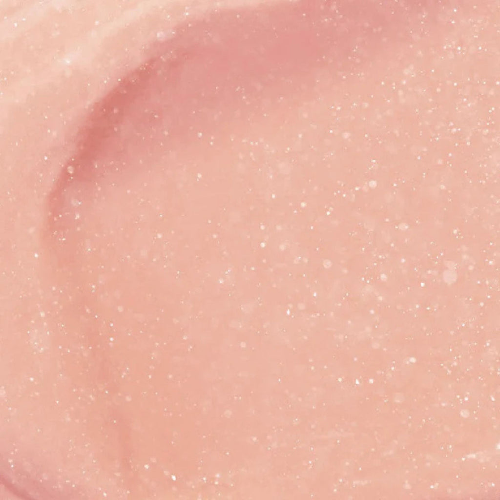 Close-up of pink lip gloss with glittery texture