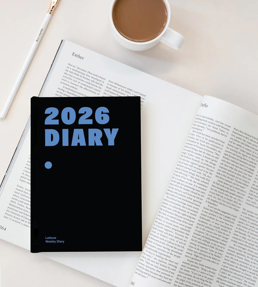 2026 diary on an open book with a cup of coffee and pen