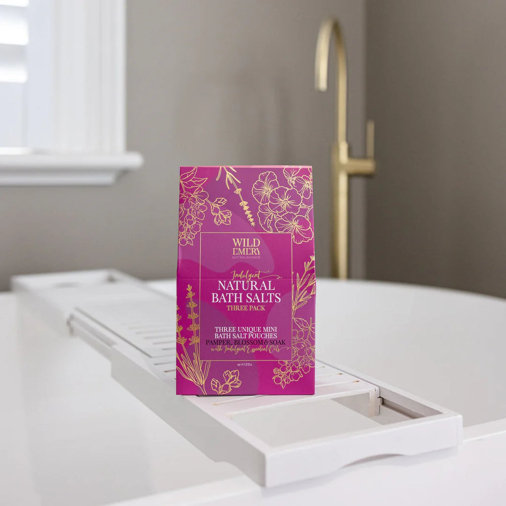 Purple packaging of Wild Earths Natural Bath Salts on a white bathtub