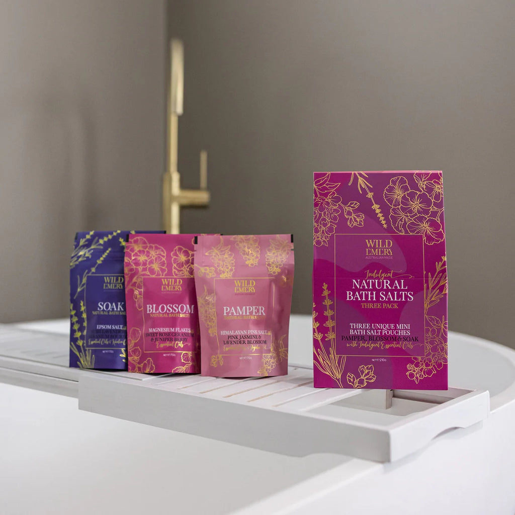 Set of Wild Earths bath salt packages on a white surface with a neutral background