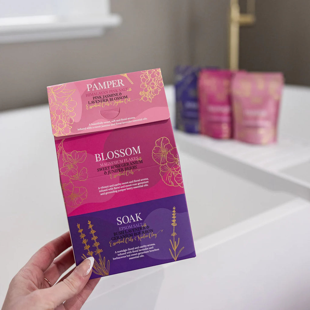 Pamper product packaging held by a hand on a bathroom counter