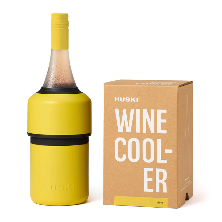 Yellow wine cooler with Huski branding next to its packaging on a white background
