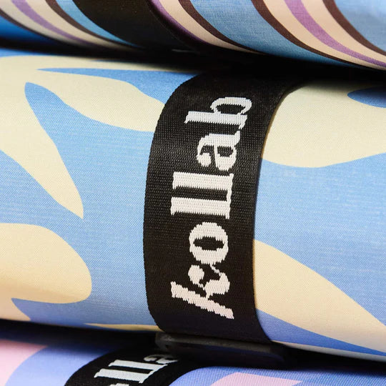 Close-up of a colorful fabric with a 'Kollab' label on a blue background