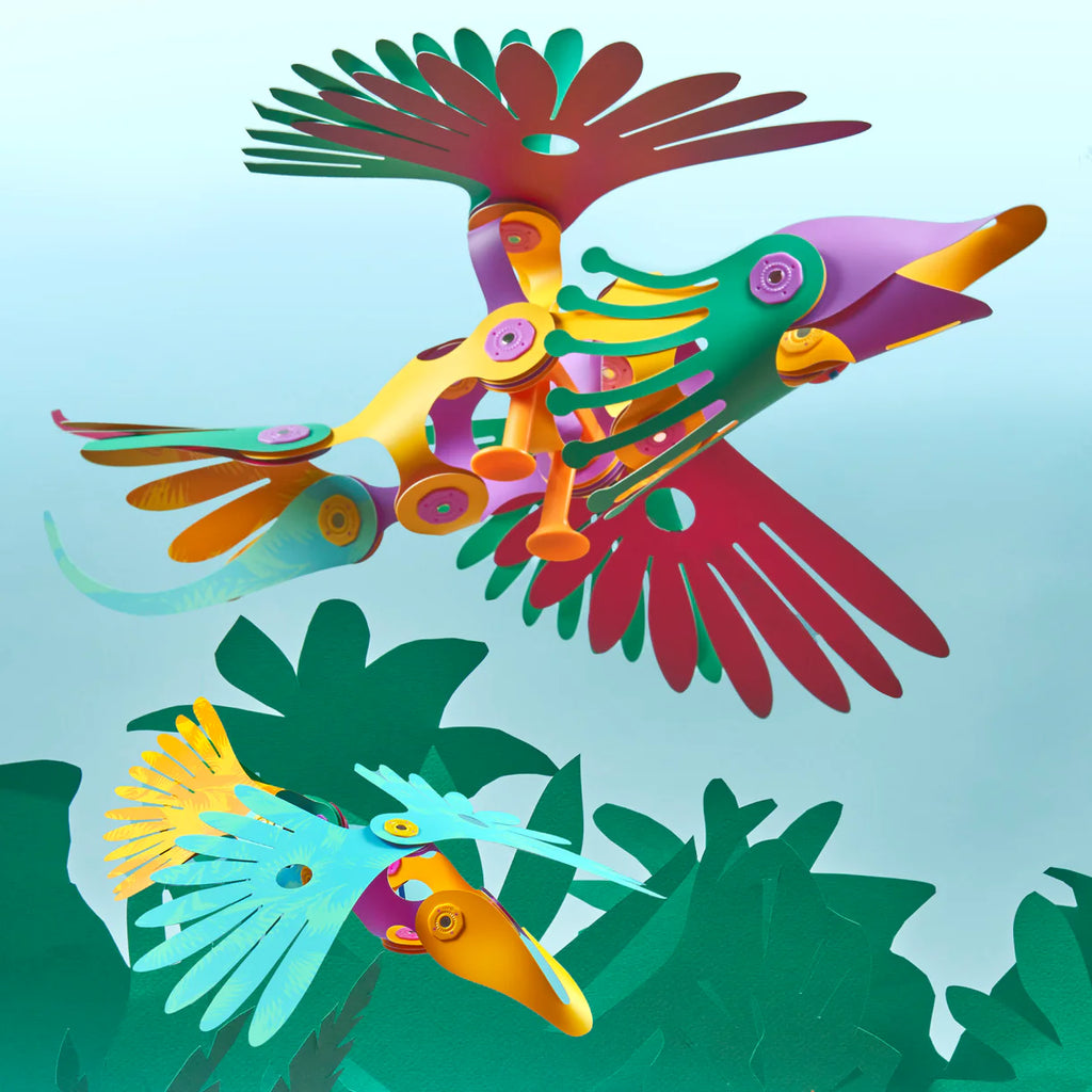 Colorful bird-shaped sculptures with a tropical leaf background