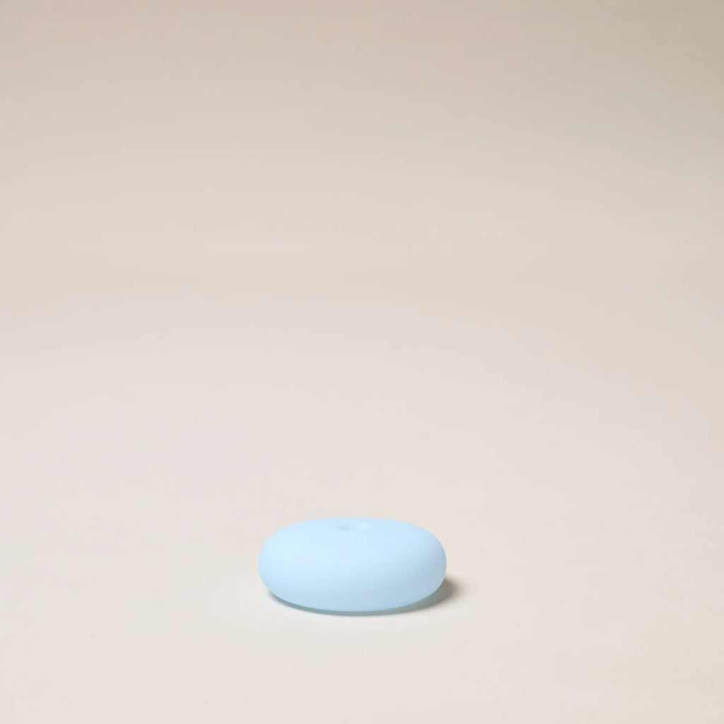 Light blue stone on a beige background