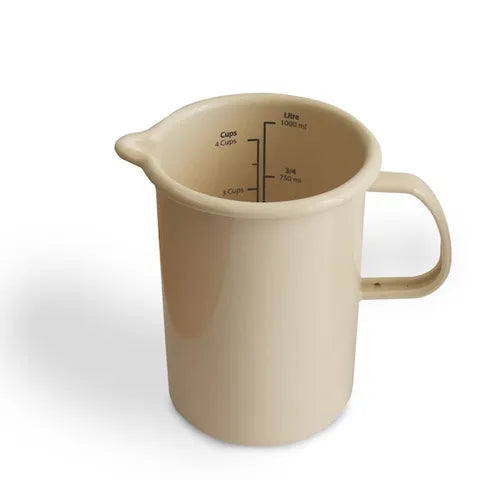 Beige measuring cup with measurement markings on a white background