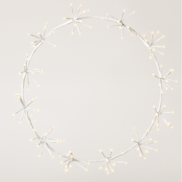 Circular string light garland on a plain background