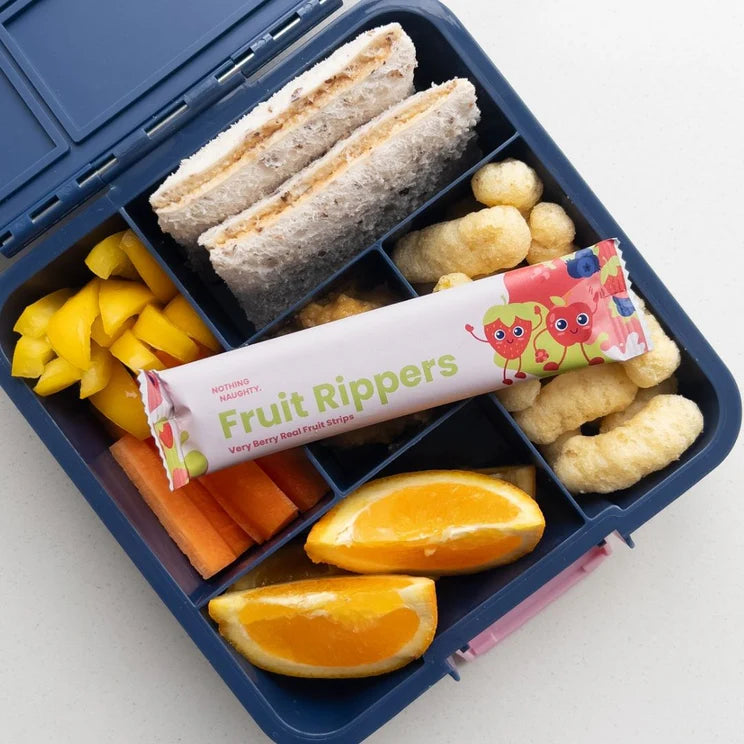 Lunchbox with sandwich, fruit, vegetables, and a bar of 'Fruit Rippers' on a white background